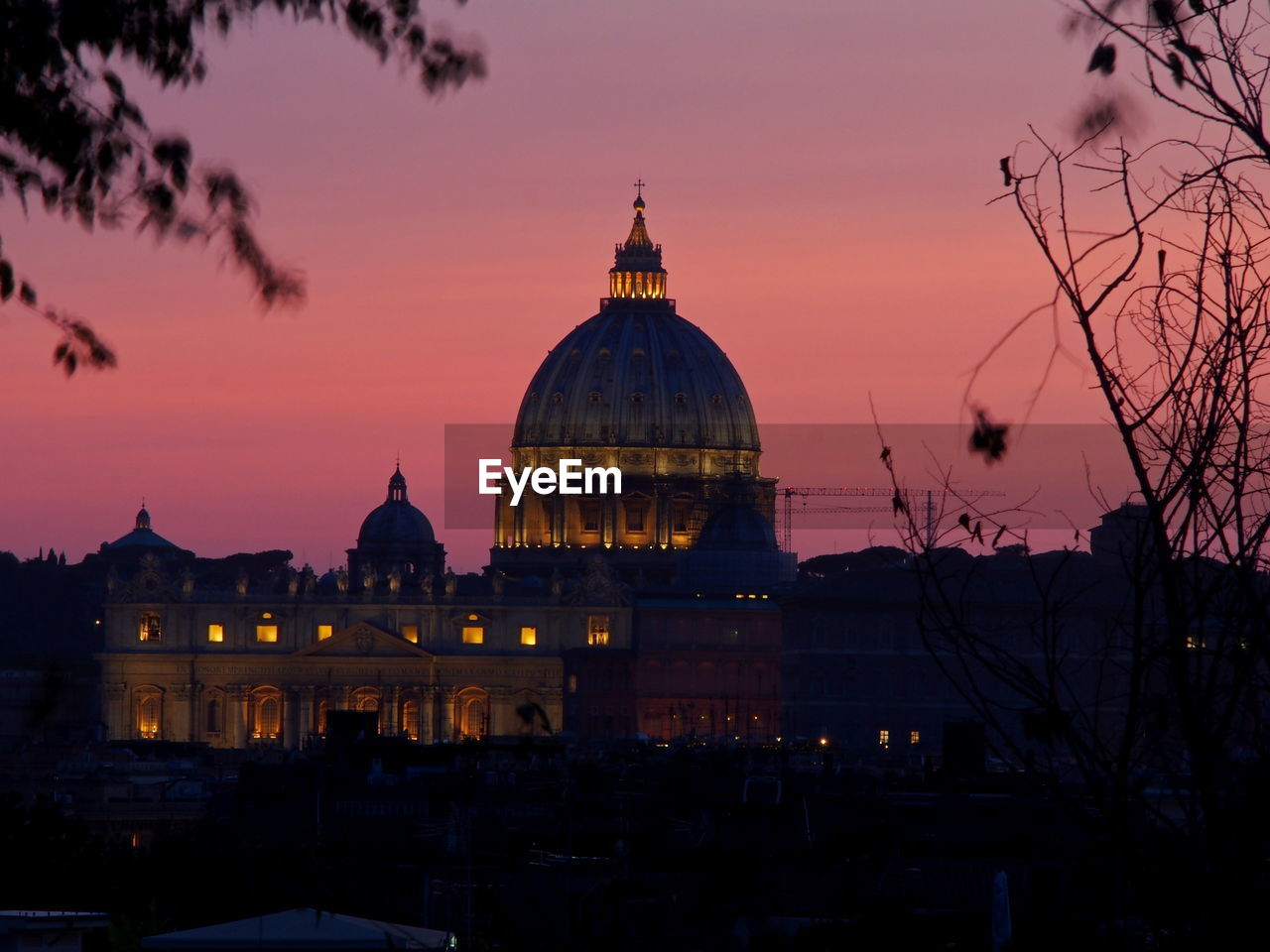 CATHEDRAL IN CITY AGAINST SKY DURING SUNSET