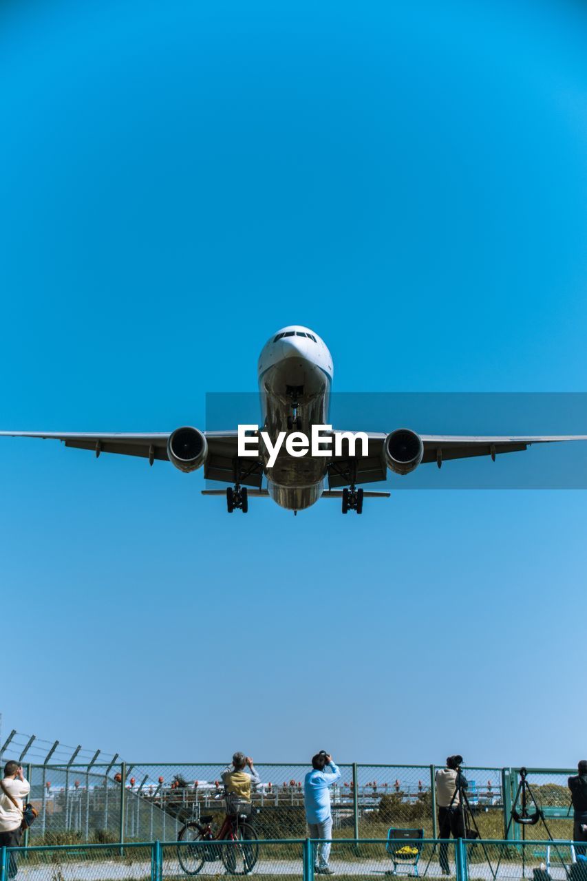 LOW ANGLE VIEW OF AIRPLANE FLYING IN SKY