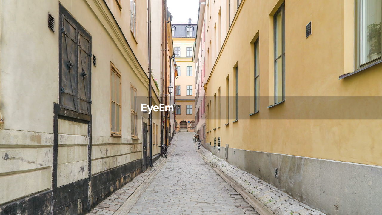 NARROW STREET AMIDST BUILDINGS