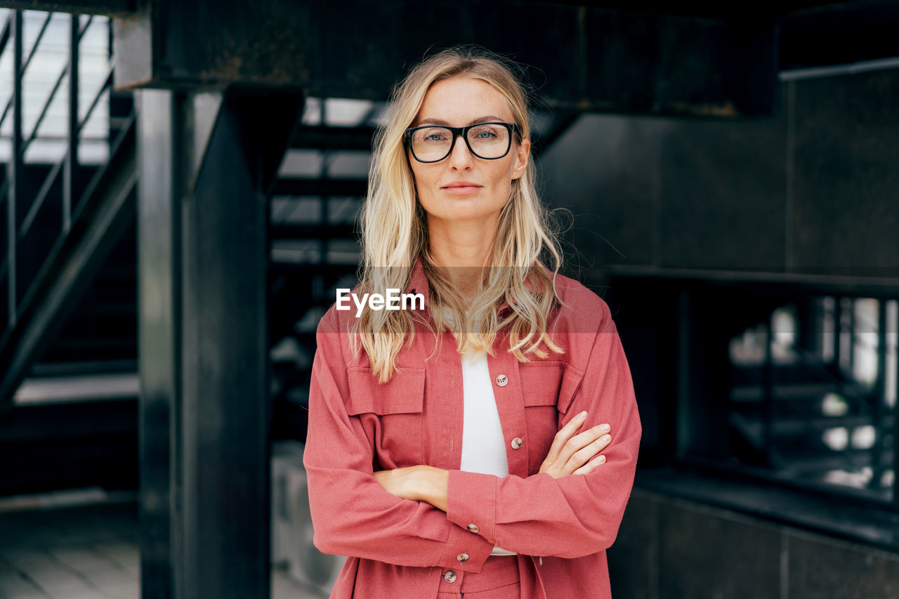 Portrait of a modern attractive confident business woman in glasses and a business suit.