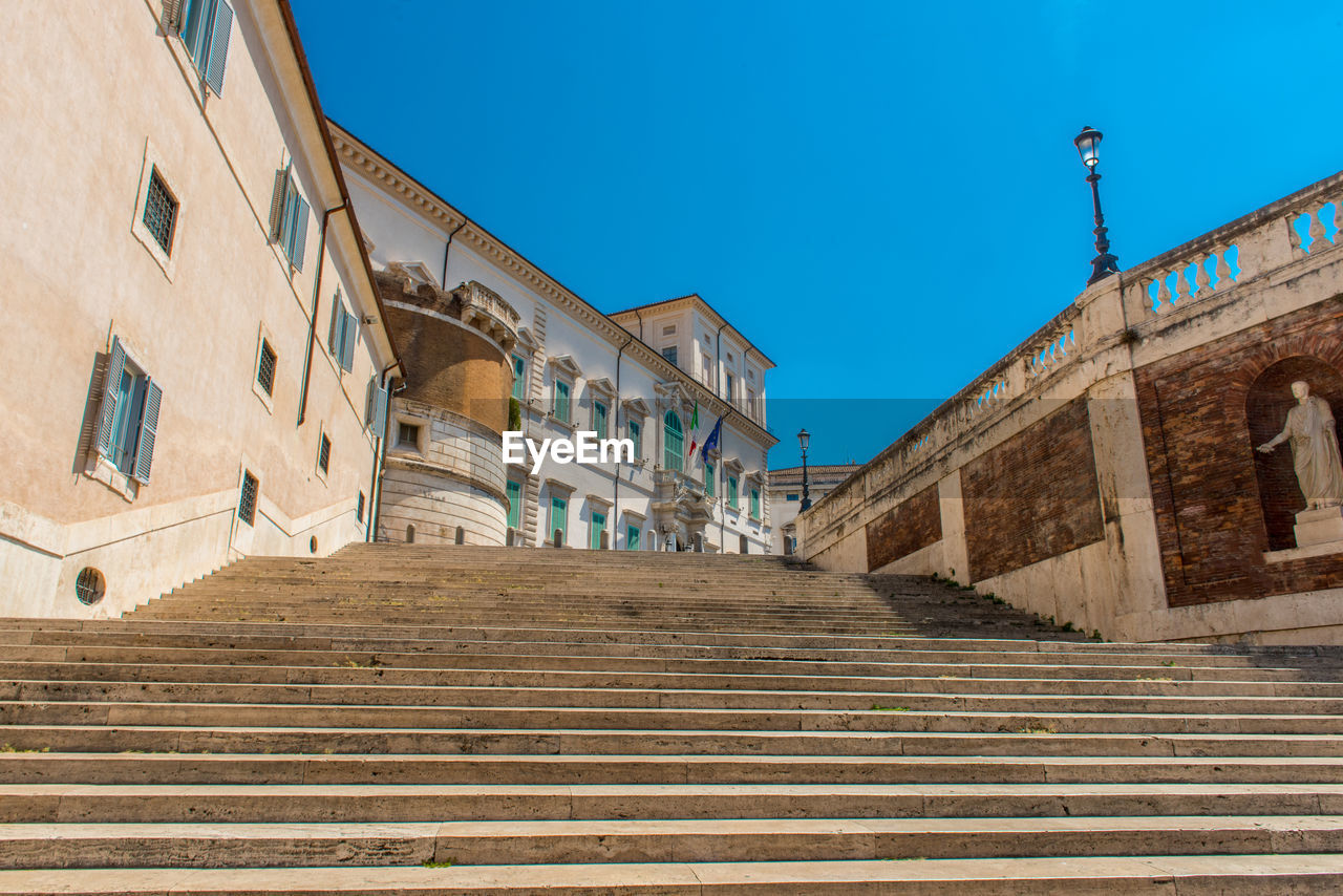 Low angle view of steps against clear blue sky