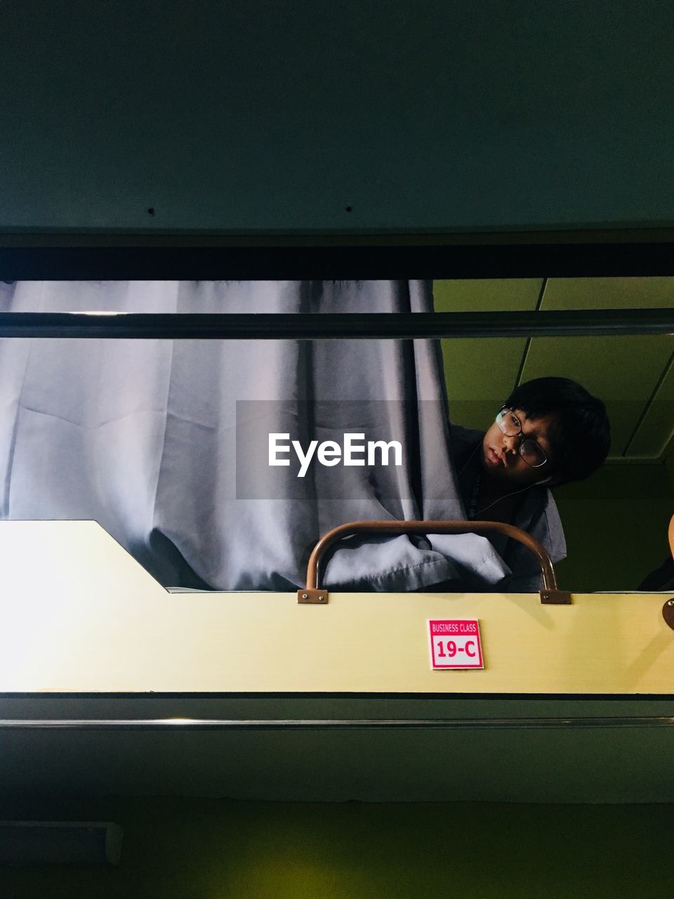 Boy lying down in train