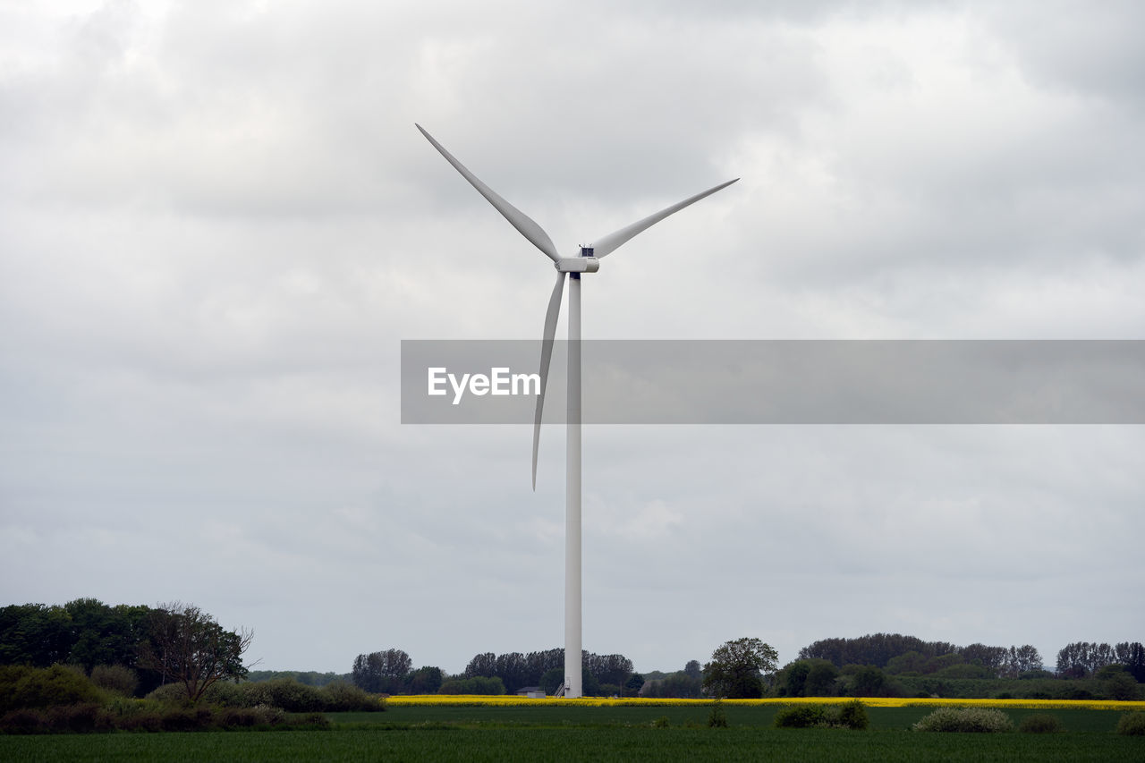 Low angle view of windmill against sky