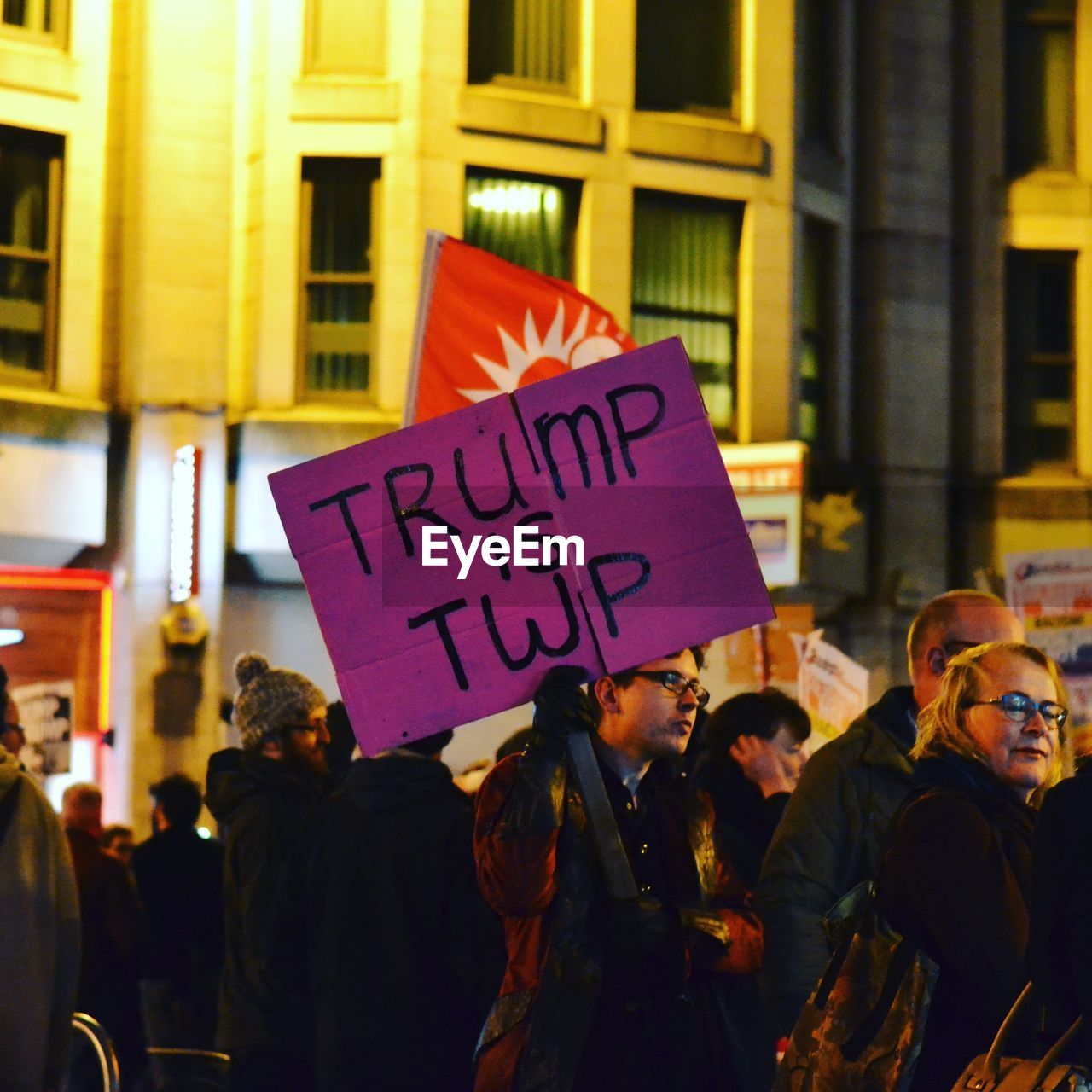 GROUP OF PEOPLE HOLDING TEXT IN CITY