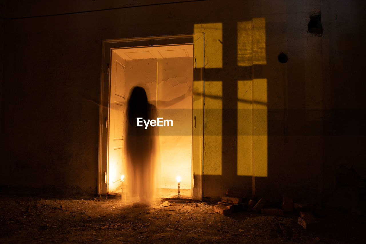 light, darkness, night, architecture, lighting, built structure, building, nature, temple, religion, indoors, yellow, entrance, fire, burning, door, dark, illuminated