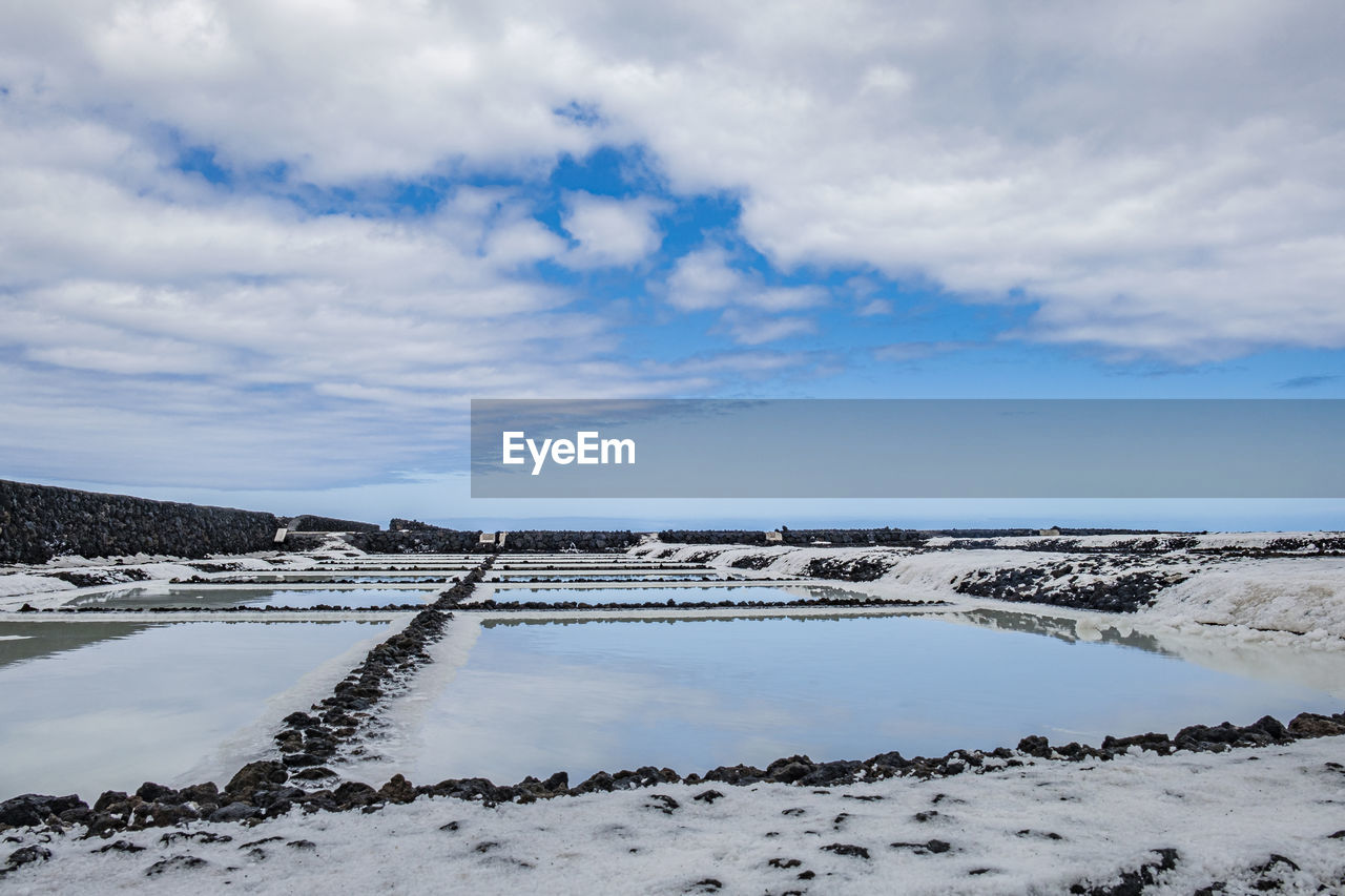 Scenic view of salt pan against sky,ready for harvest