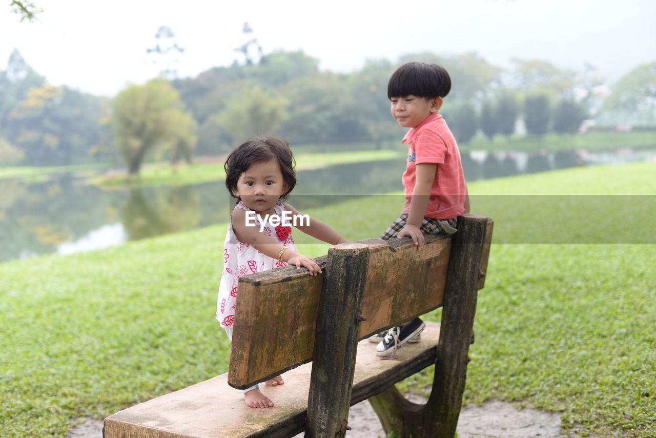 Cute siblings on bench at park