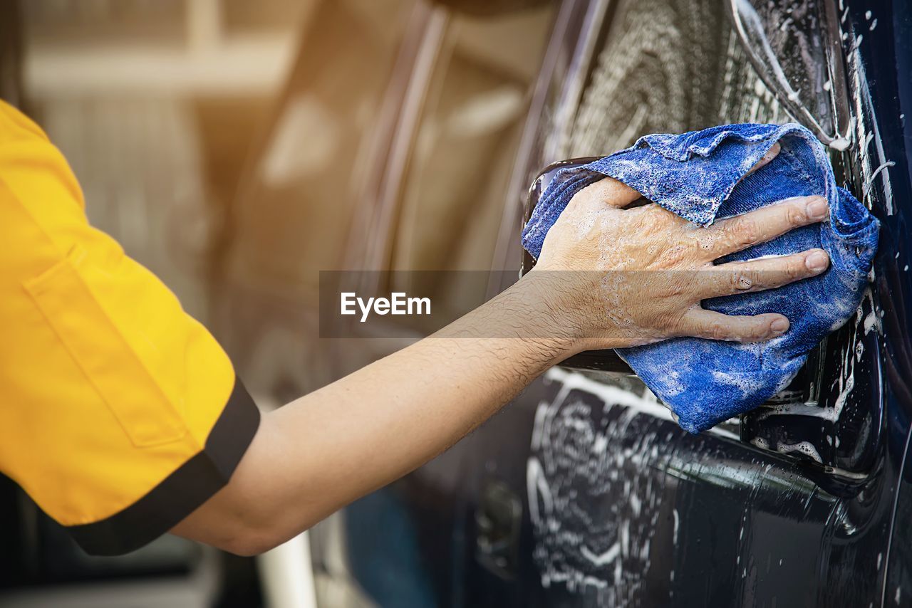 Man wash car using shampoo - every day life car care concept