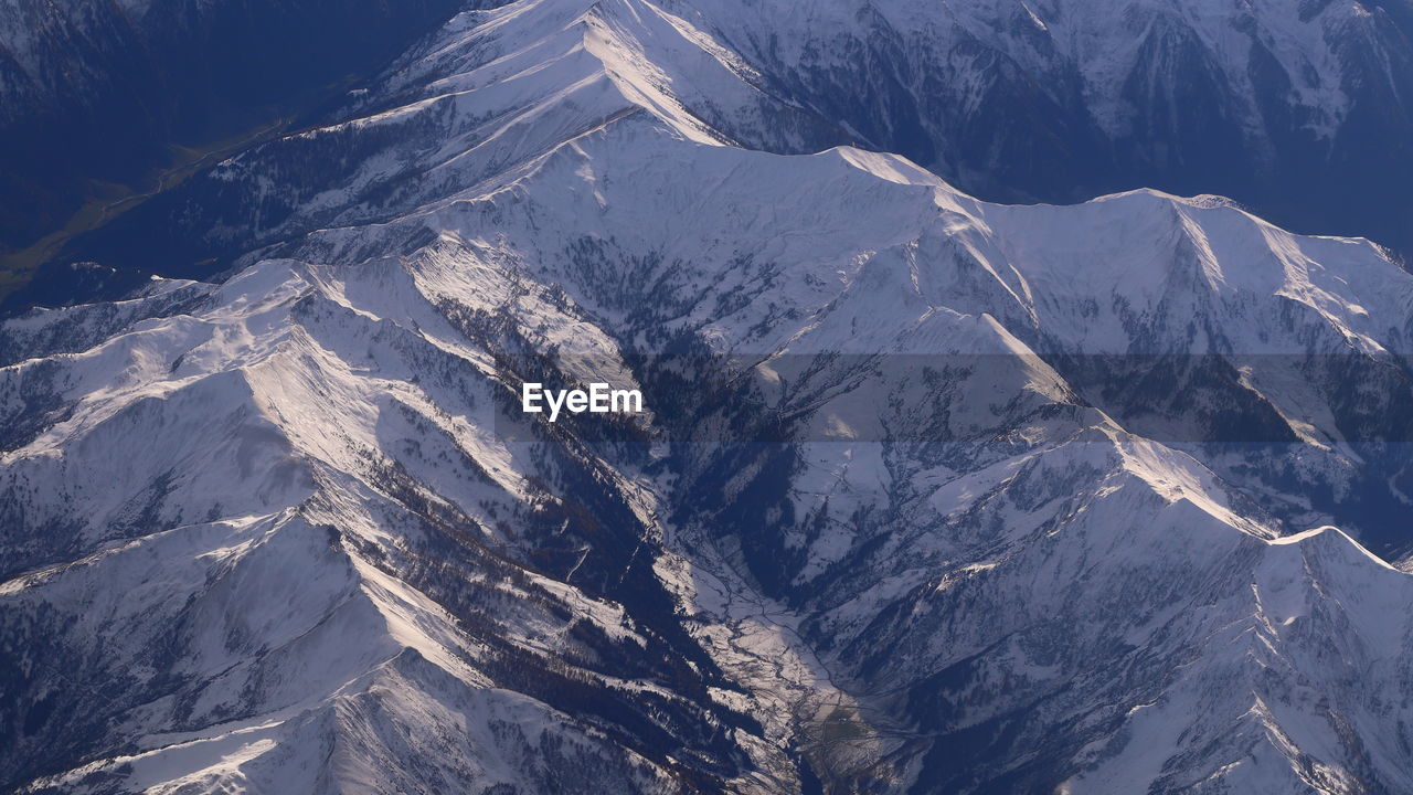 AERIAL VIEW OF SNOW COVERED MOUNTAIN