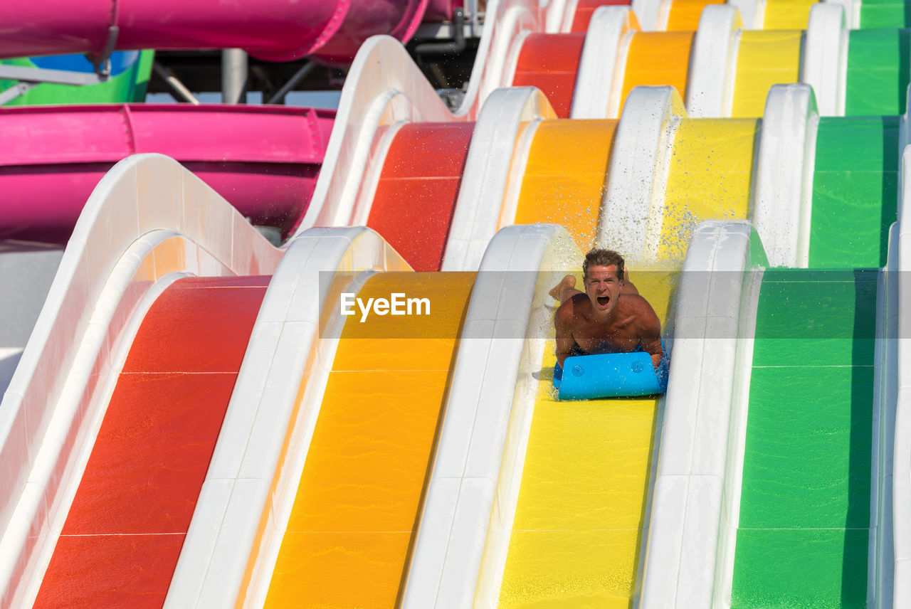 Low angle view of man on water slide