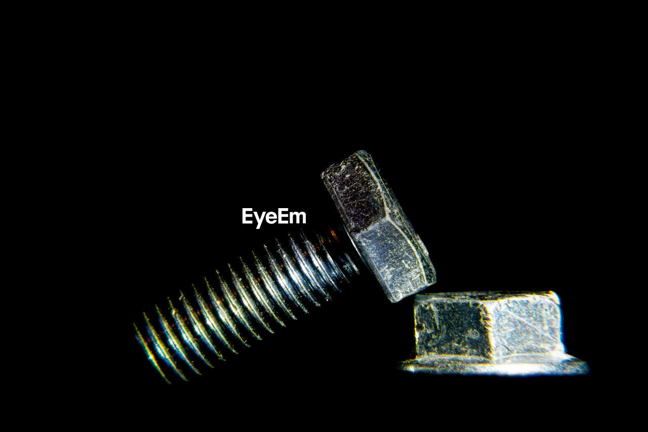 CLOSE-UP OF ILLUMINATED LAMP AGAINST BLACK BACKGROUND