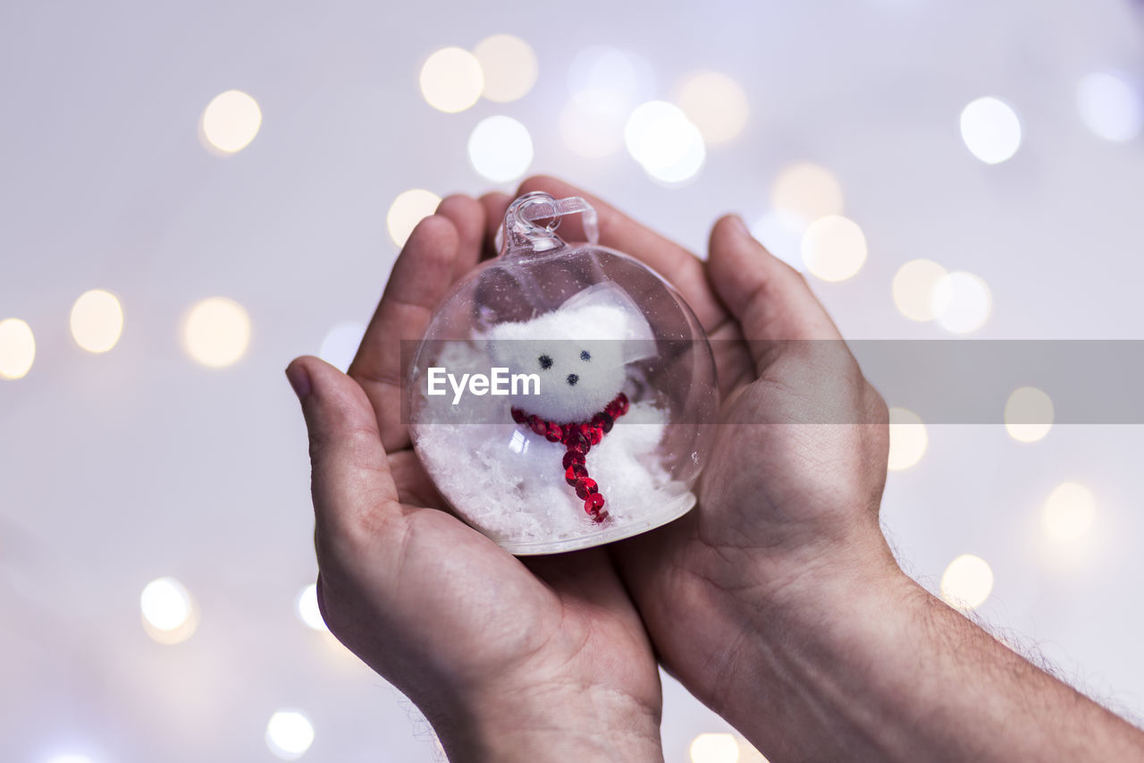 Beautiful christmas glass ball. christmas toy in the hands . merry christmas and happy new year.