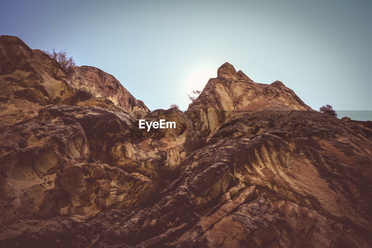 Low angle view of rock formation against clear sky