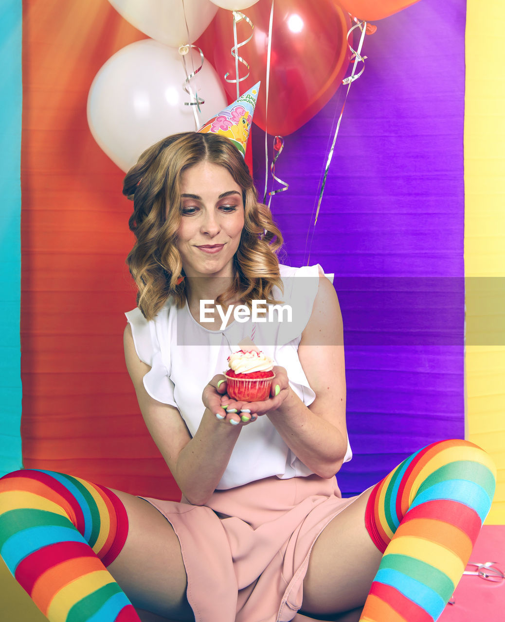 Portrait of a beautiful woman in rainbow stockings for her birthday