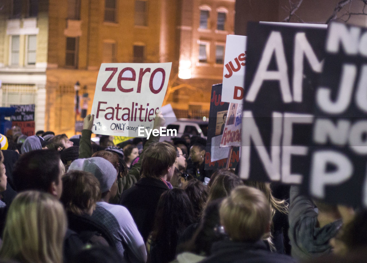 People protesting against police brutality on street during night