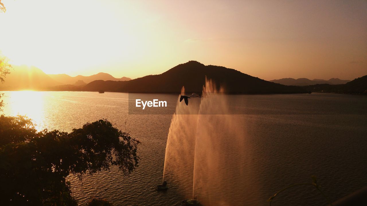 Scenic view of fountain in sea against sky