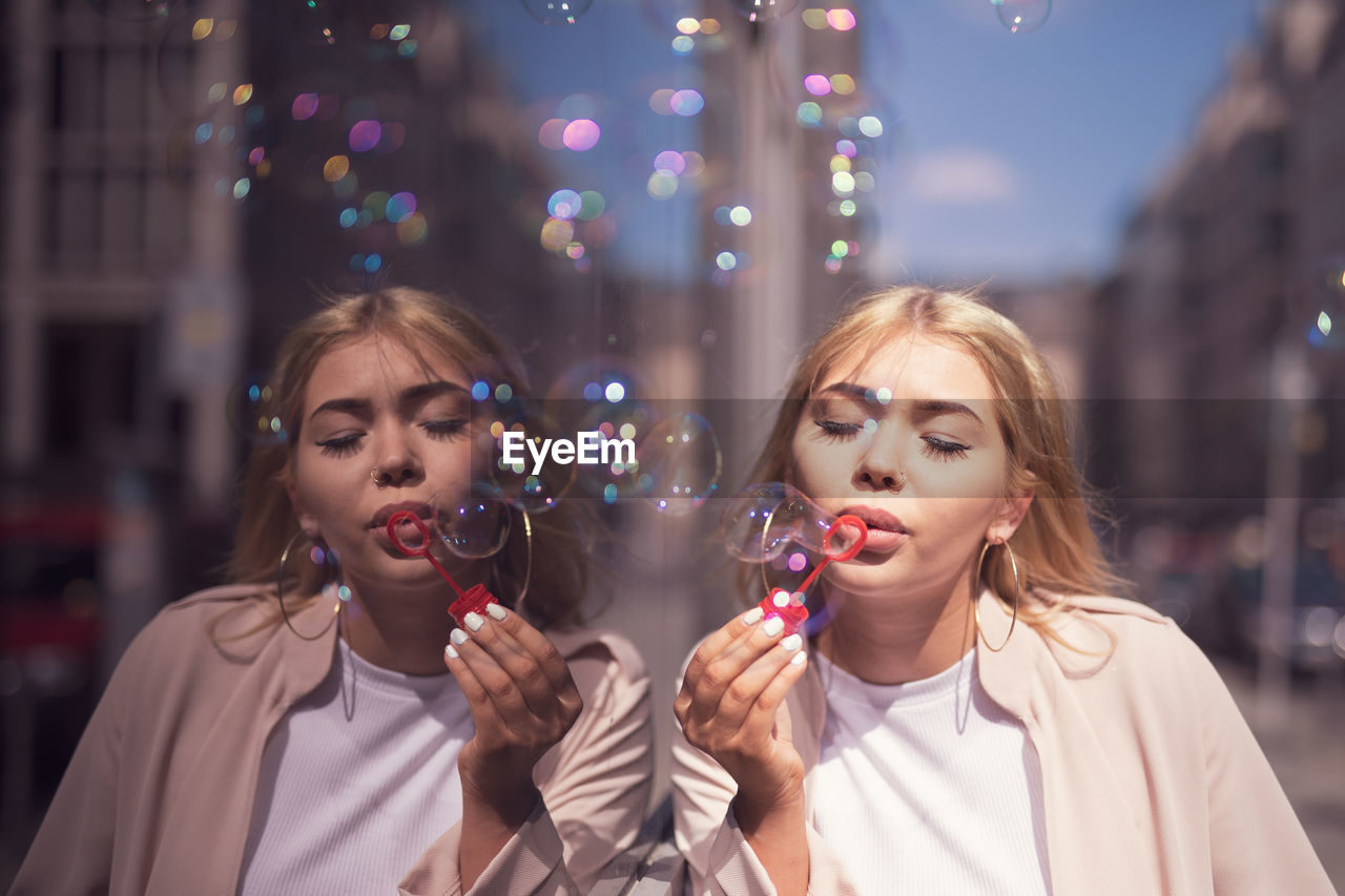 PORTRAIT OF A BEAUTIFUL YOUNG WOMAN IN BUBBLES