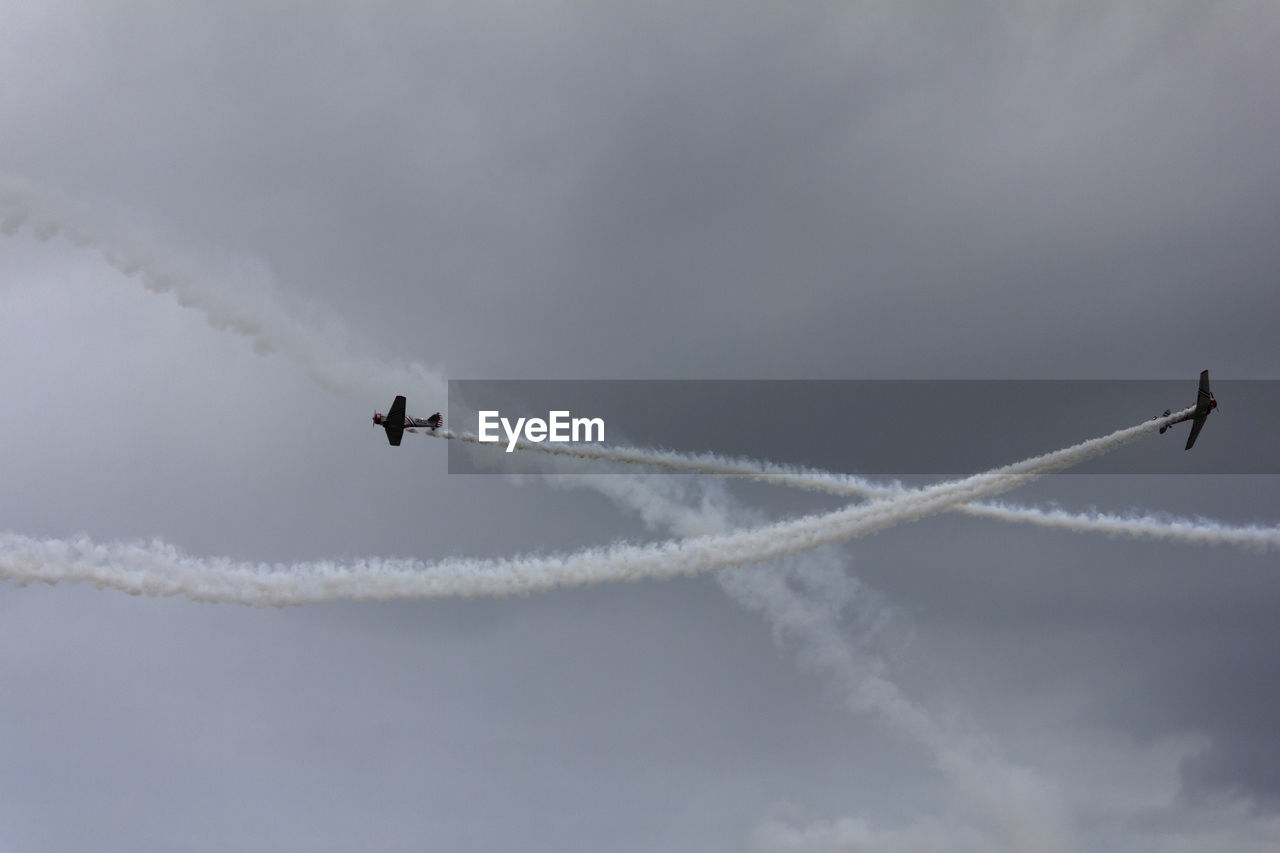 Low angle view of airplane flying against sky