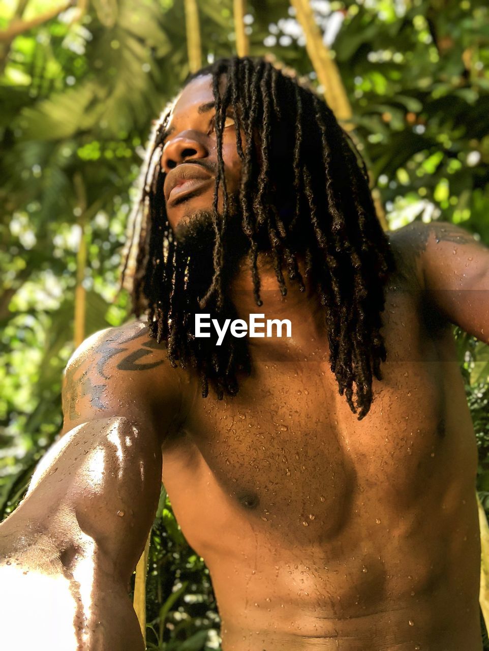 Close-up of shirtless caribbean man looking at camera