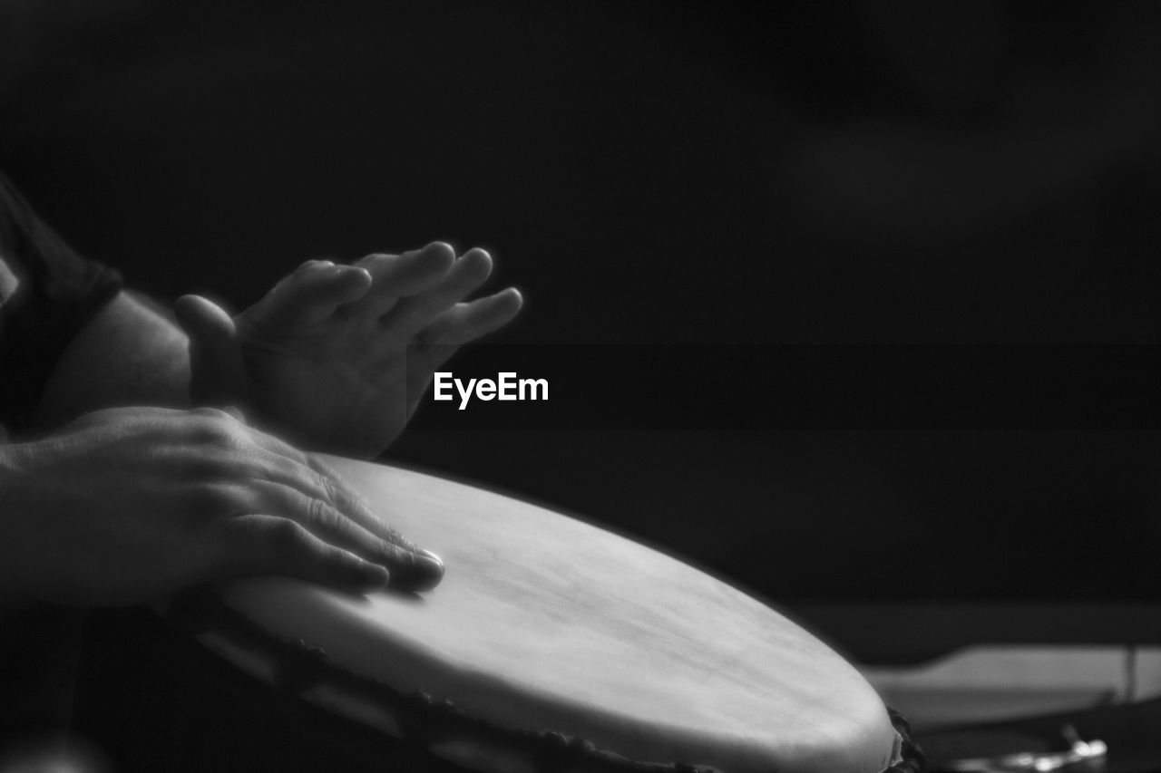 Close-up of hands playing a drum