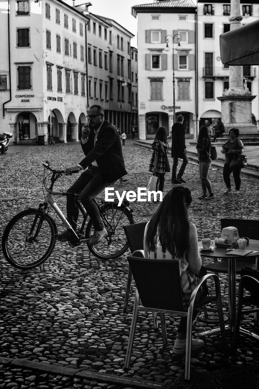 MAN SITTING ON CHAIR AT CITY