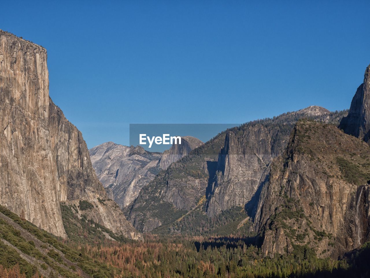 Scenic view of mountains against clear blue sky