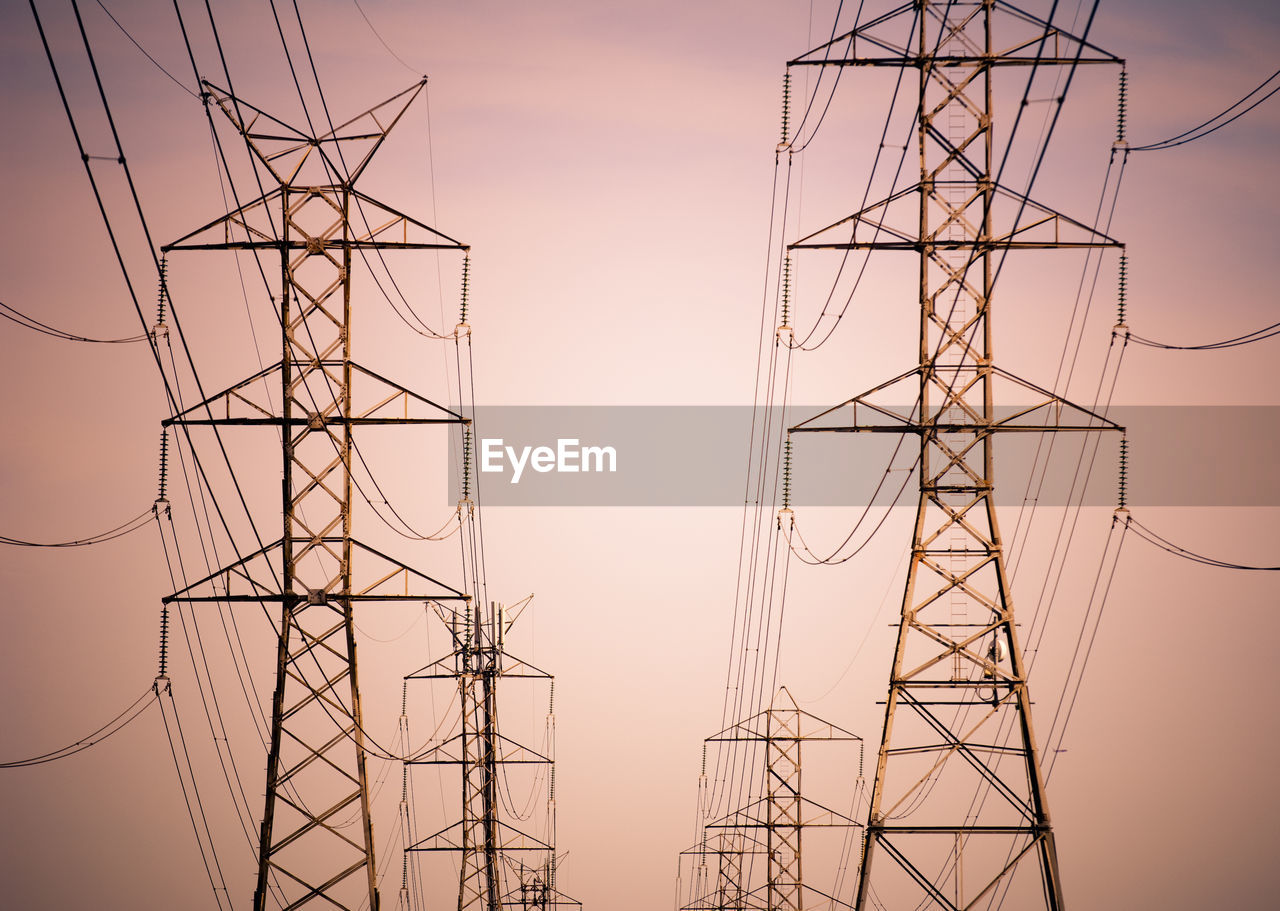 LOW ANGLE VIEW OF ELECTRICITY PYLON AGAINST SKY AT DUSK