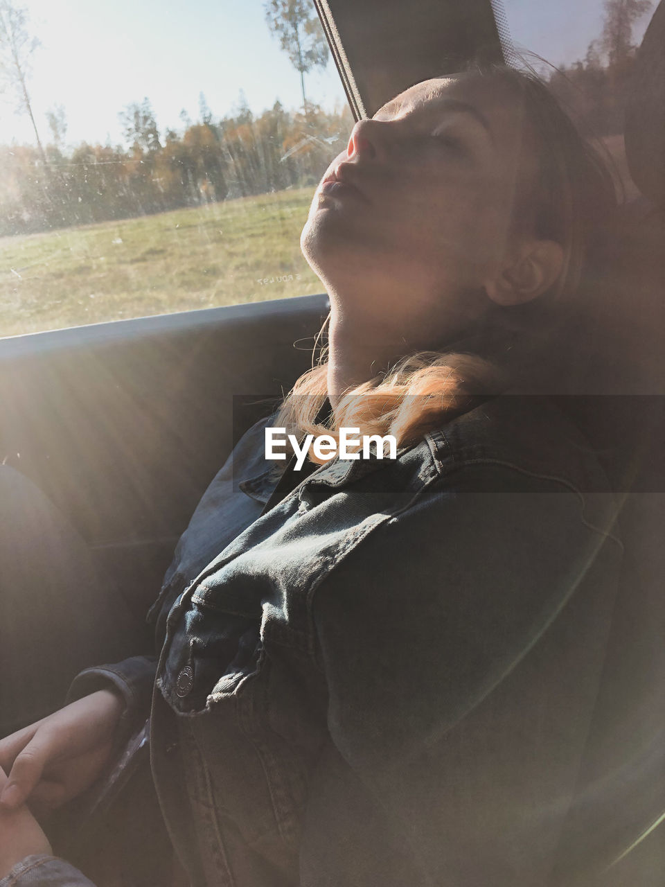 Teenage girl sleeping in car