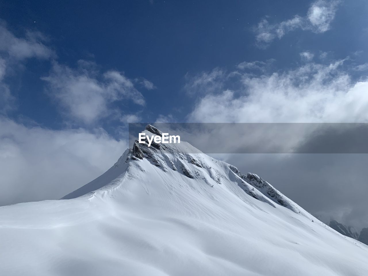 Scenic view of snowcapped mountain against sky