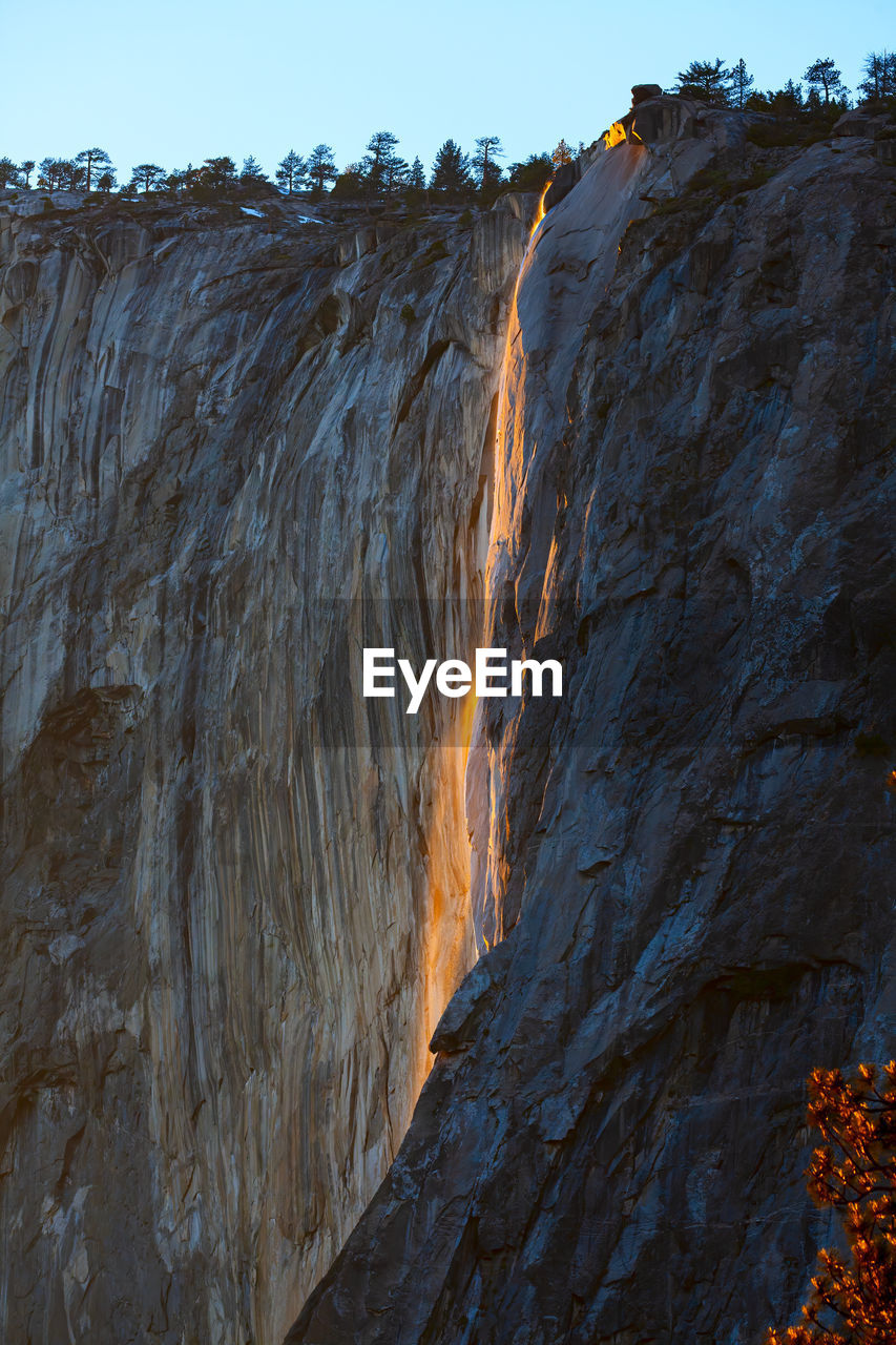low angle view of rock formations against sky