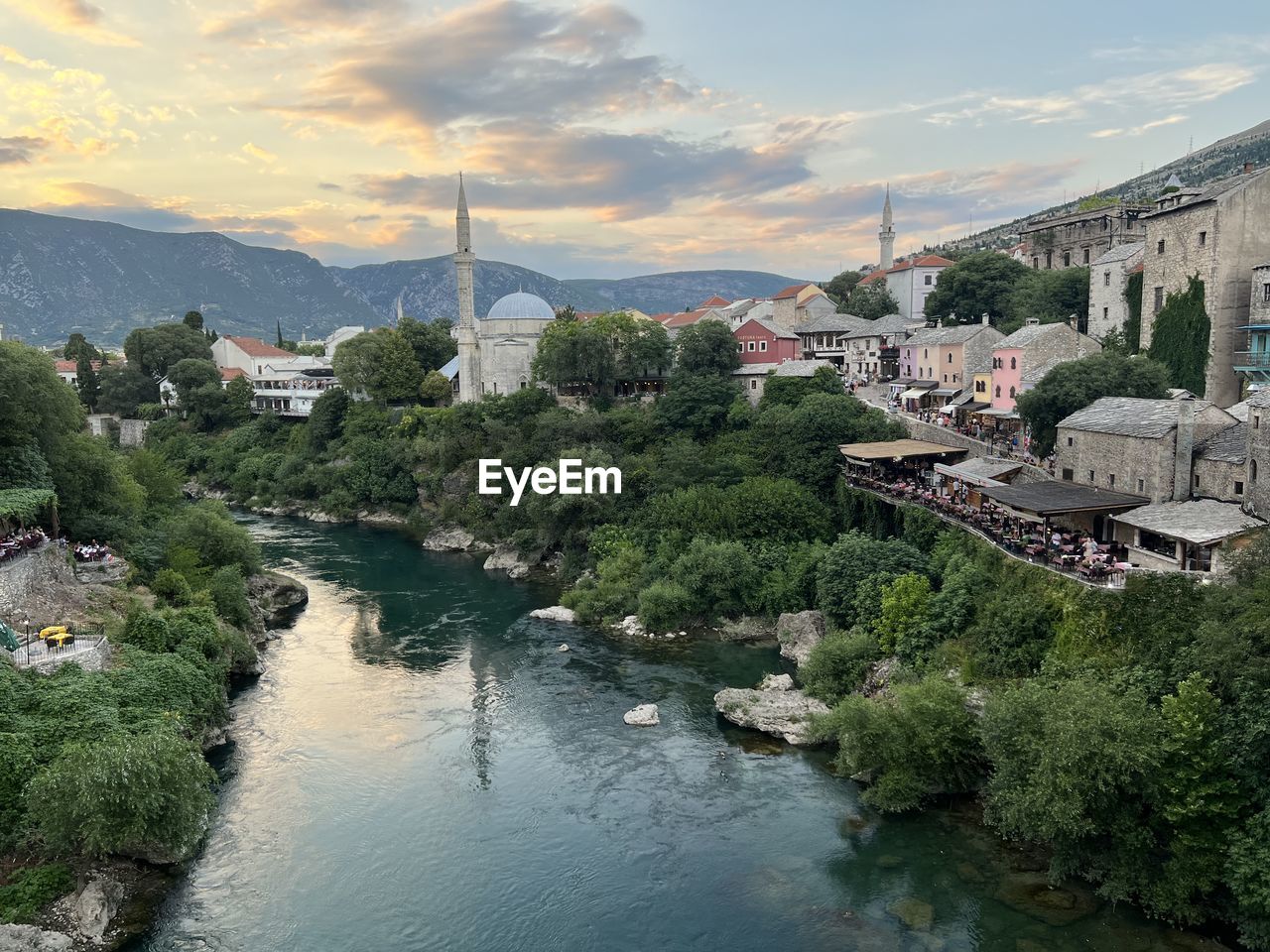 High angle view of townscape by river against sky