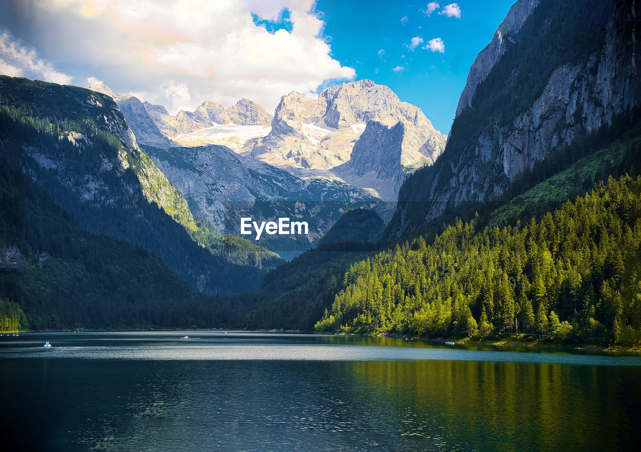 Scenic view of lake and mountains against sky