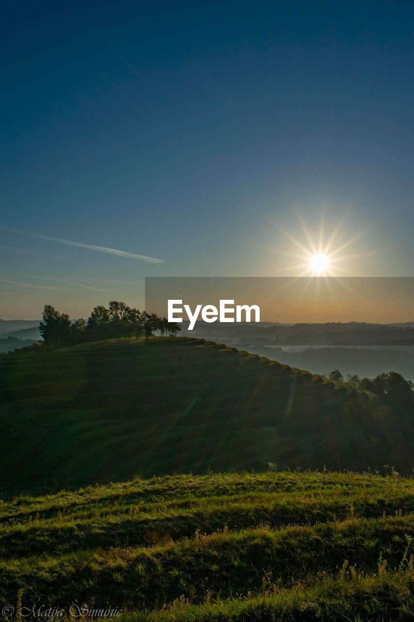 Scenic view of landscape against sky during sunset