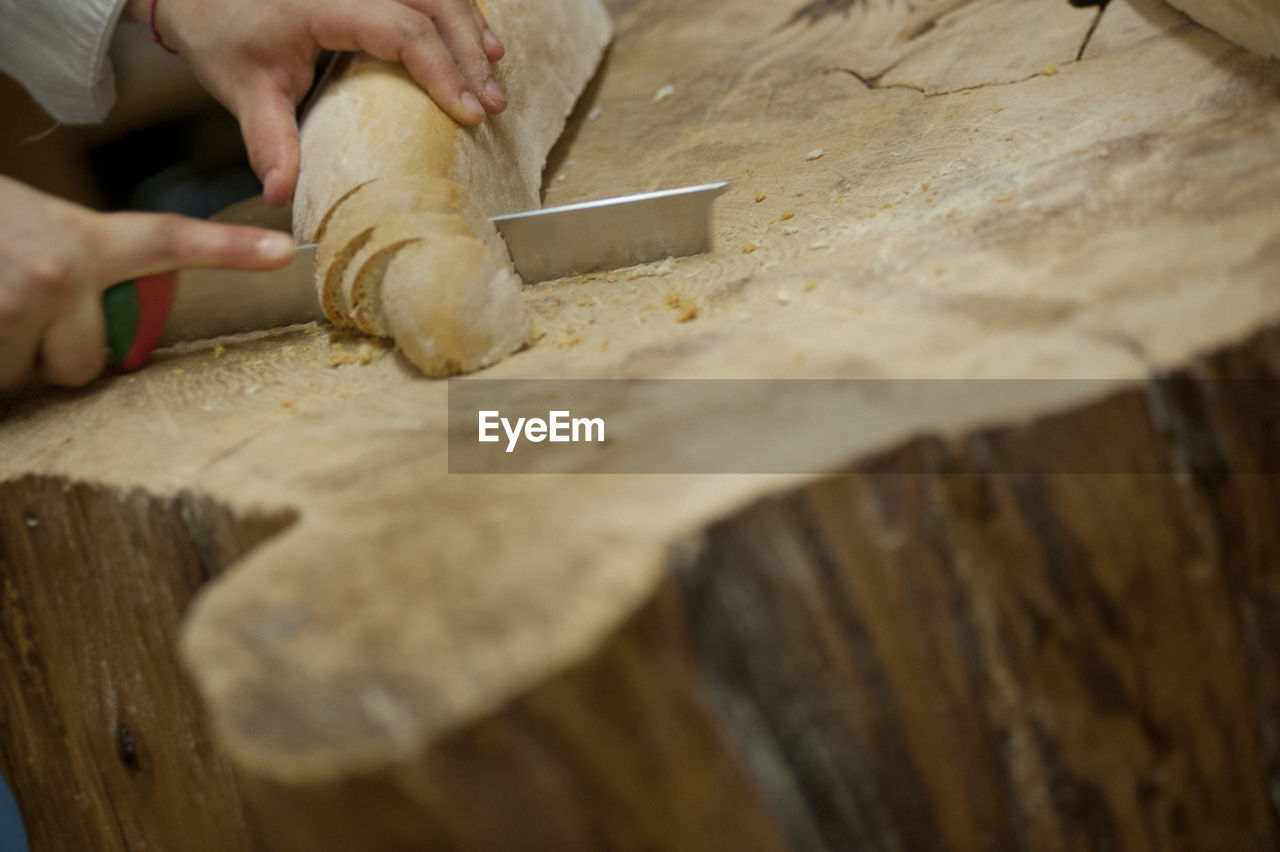 MIDSECTION OF MAN WORKING AT TABLE