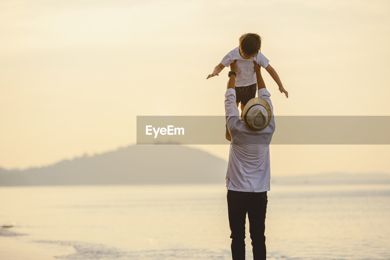 Father and son enjoying at beach