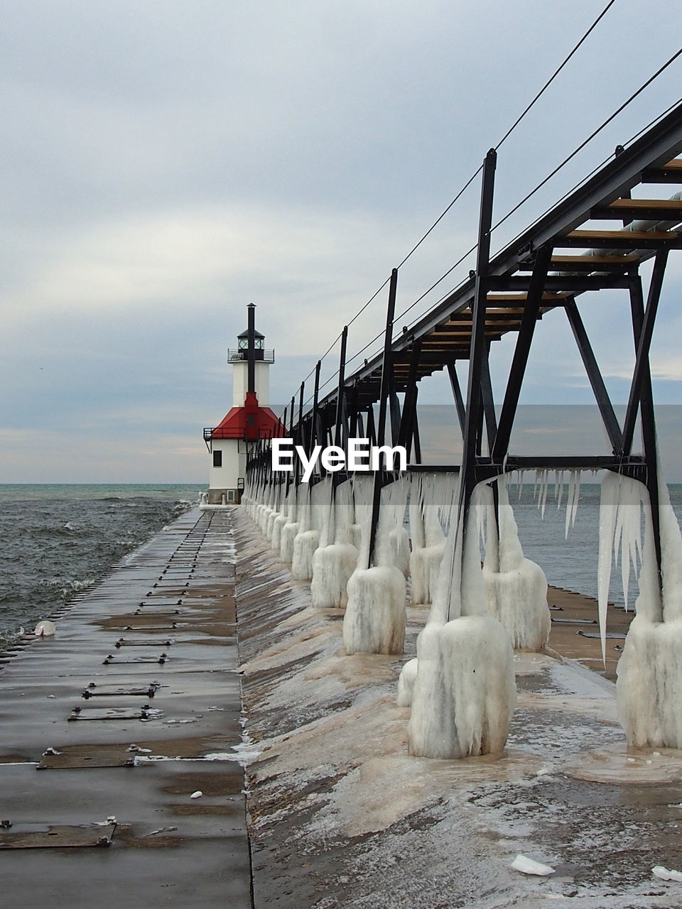 Pier over sea against sky