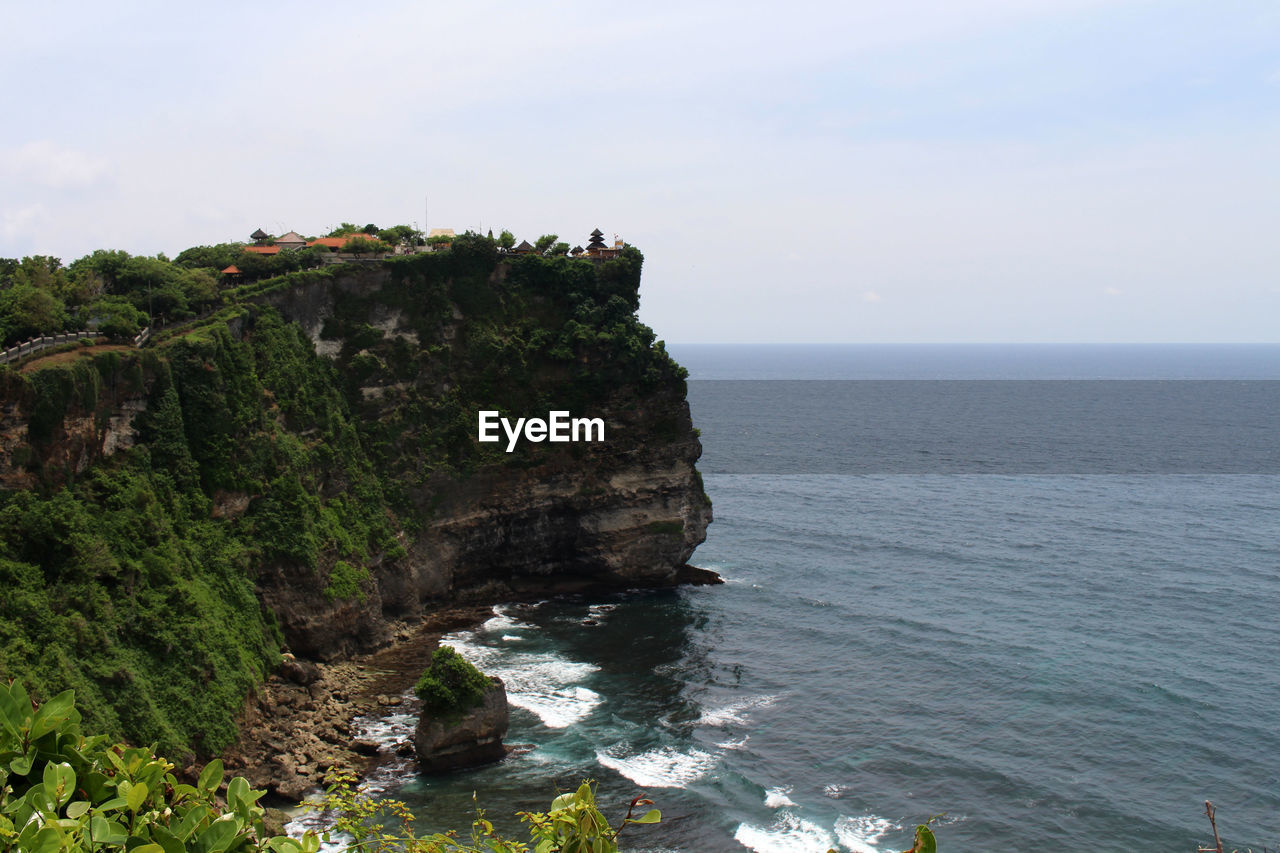 sea, water, cliff, land, scenics - nature, beauty in nature, sky, coast, rock, nature, beach, ocean, shore, horizon, horizon over water, body of water, tranquility, terrain, tranquil scene, bay, rock formation, plant, idyllic, no people, day, non-urban scene, islet, coastline, travel destinations, outdoors, vacation, cove, travel, tower, environment, promontory, tourism, cloud, high angle view, tree