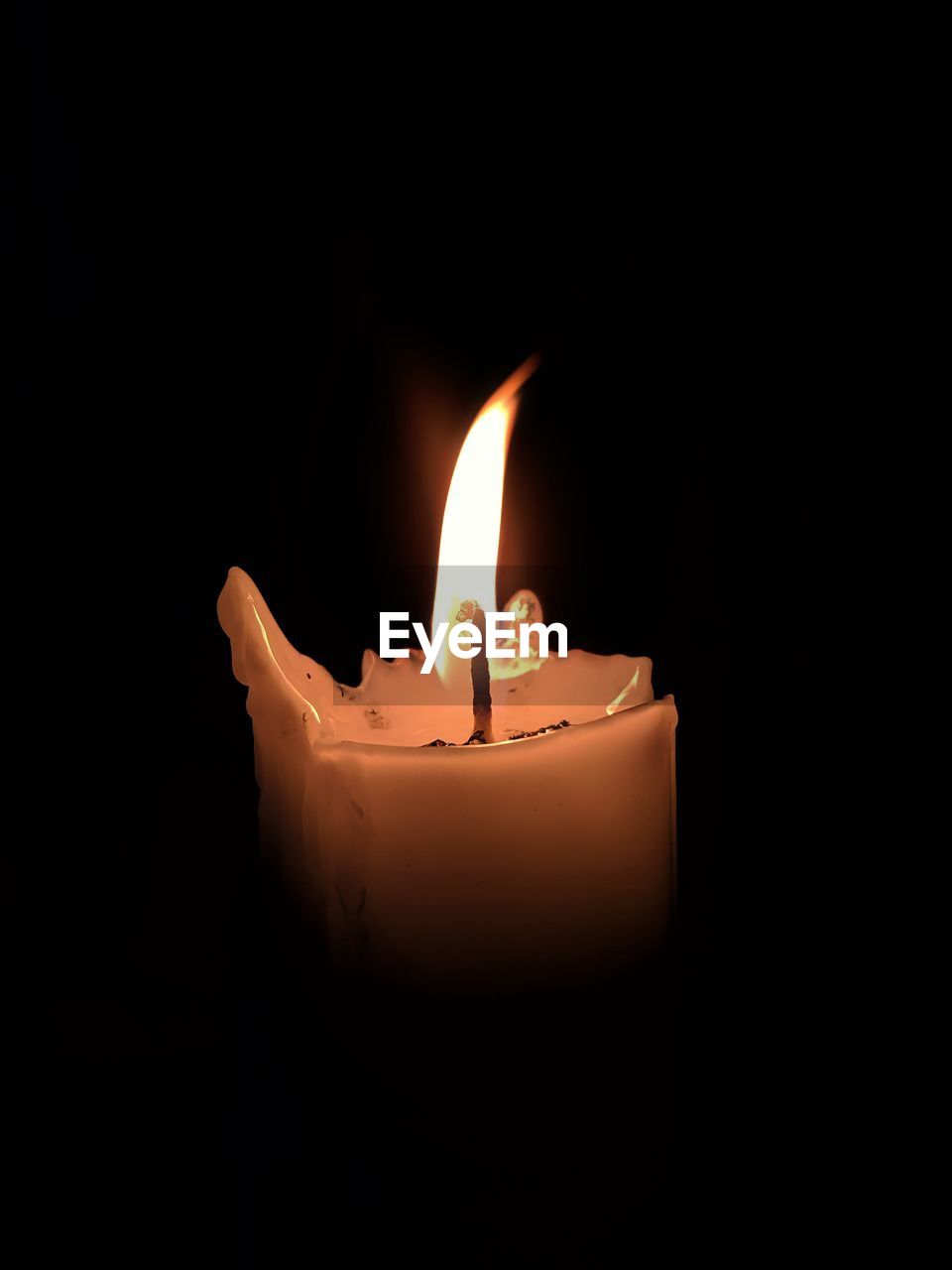 CLOSE-UP OF BURNING CANDLE
