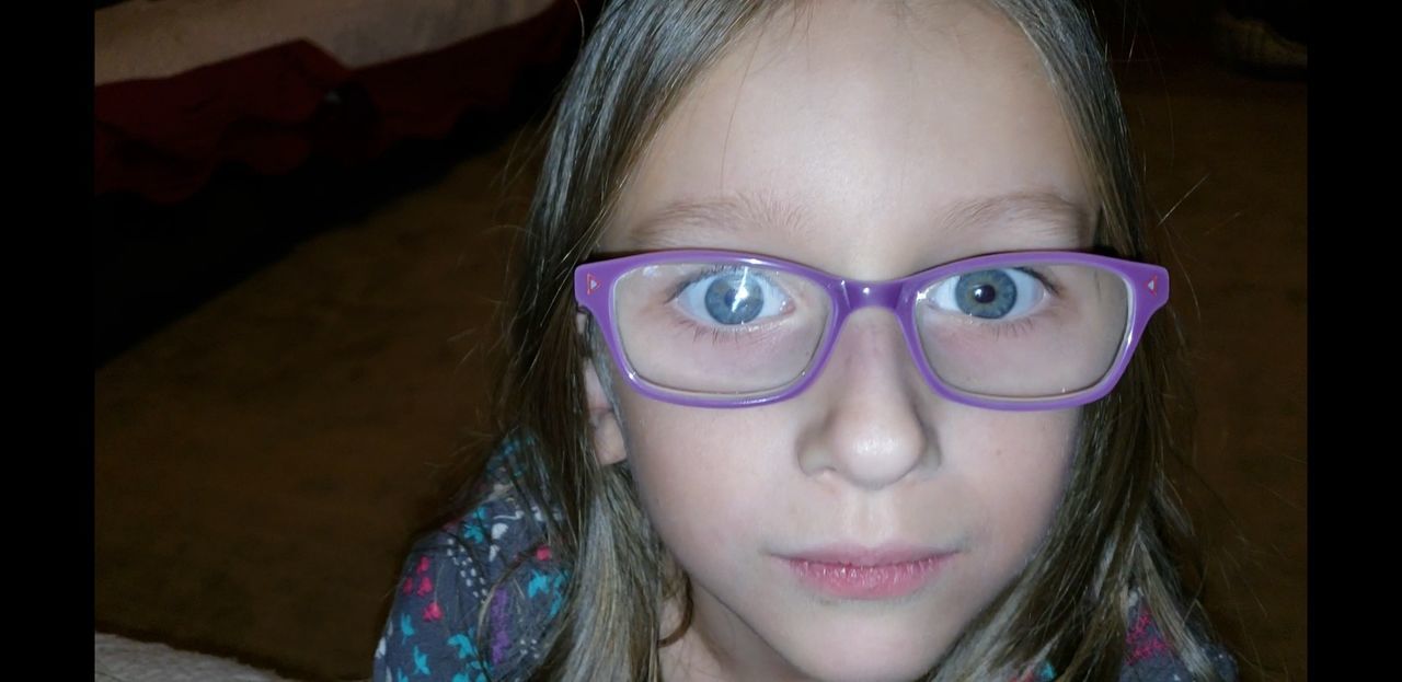 Close-up portrait of girl wearing eyeglasses