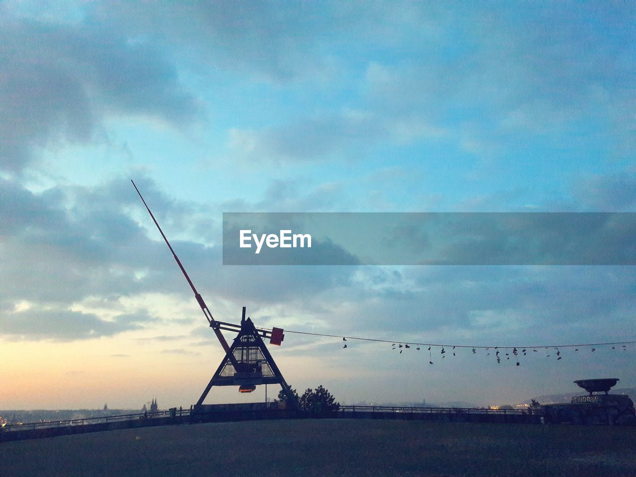 SILHOUETTE WINDMILL AGAINST SKY AT DUSK