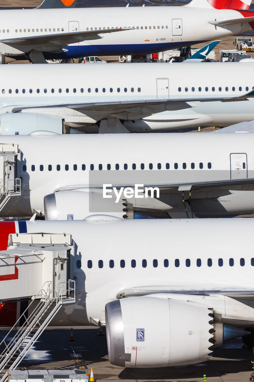 HIGH ANGLE VIEW OF AIRPLANE AT AIRPORT RUNWAY