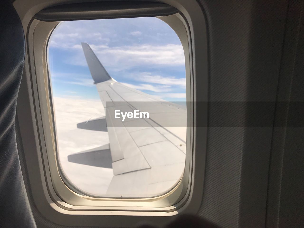 VIEW OF AIRPLANE WING SEEN FROM WINDOW