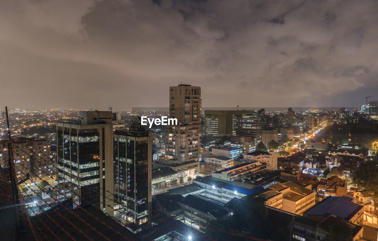 High angle view of illuminated buildings in city at night