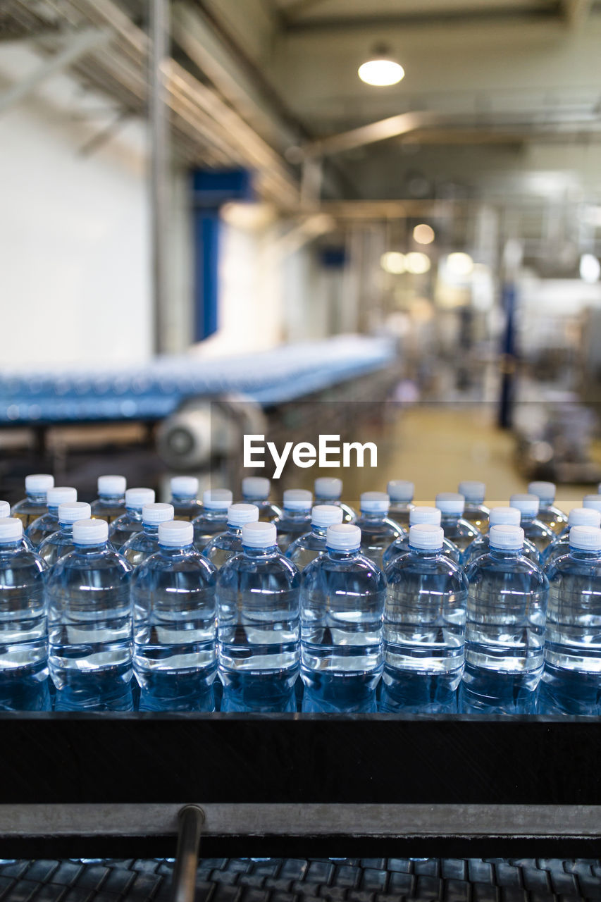 Bottles on conveyor belt at factory