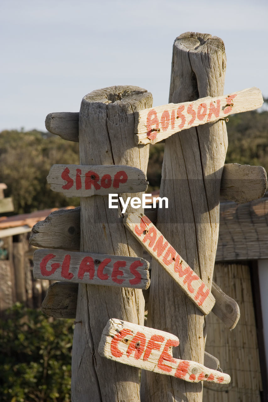 CLOSE-UP OF WOODEN POST BY WALL