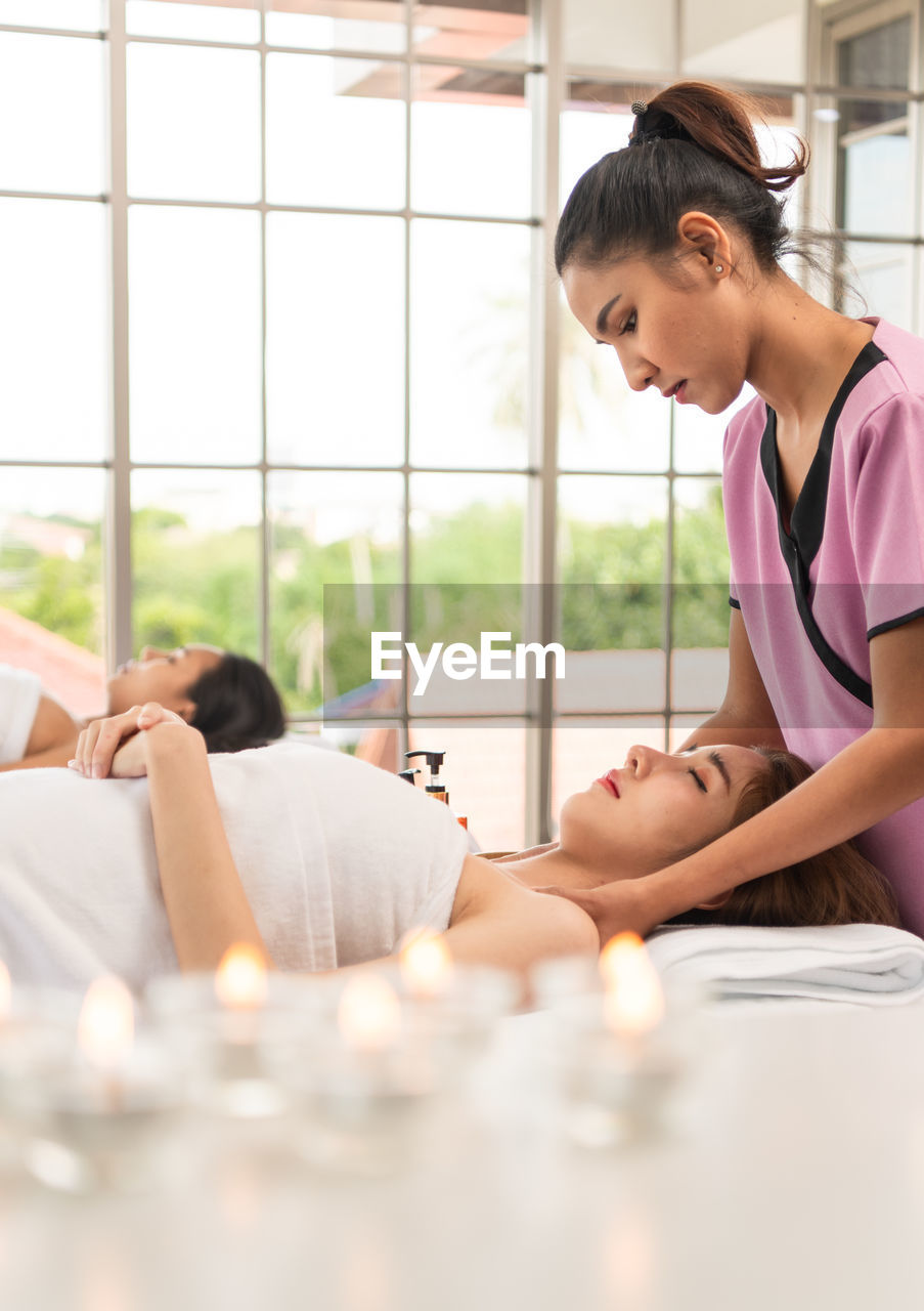 Portrait of young beautiful asian woman enjoys massage in a luxury spa resort