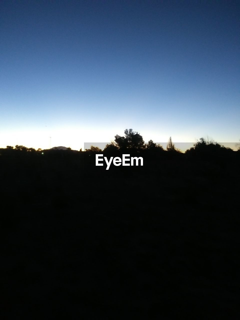 SILHOUETTE LANDSCAPE AGAINST CLEAR SKY DURING SUNSET