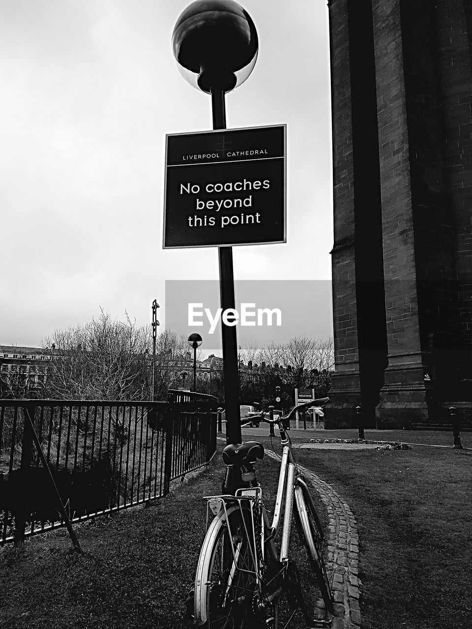 ROAD SIGN BY STREET AGAINST SKY