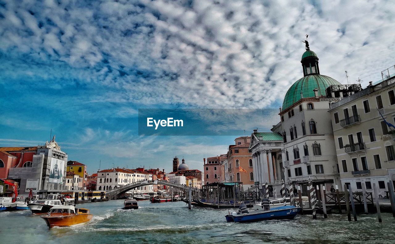 Buildings by grand canal in city