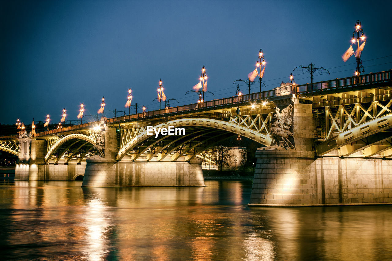 Illuminated margaret bridge over river against sky at dusk